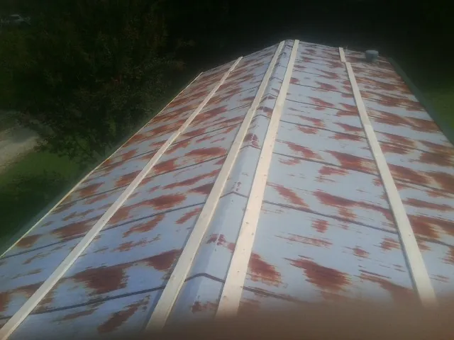 Rusted metal roof panels with new wood purlins before replacement — Storm Damage Roof Repair in Keswick by Roofing Brothers