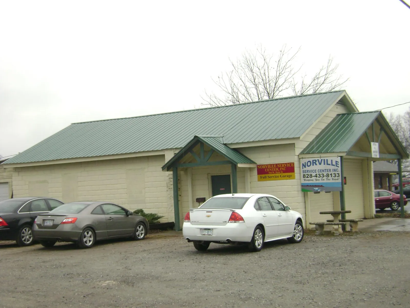 Green metal roof on a service garage with a covered entry in Keswick